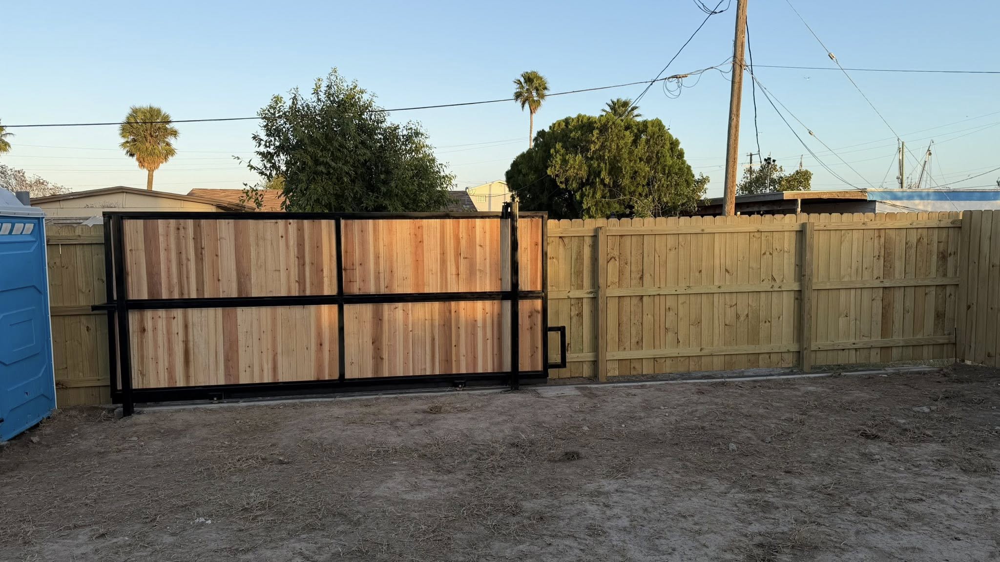 Professional wood and metal fence with gate by Border Fencing Co.